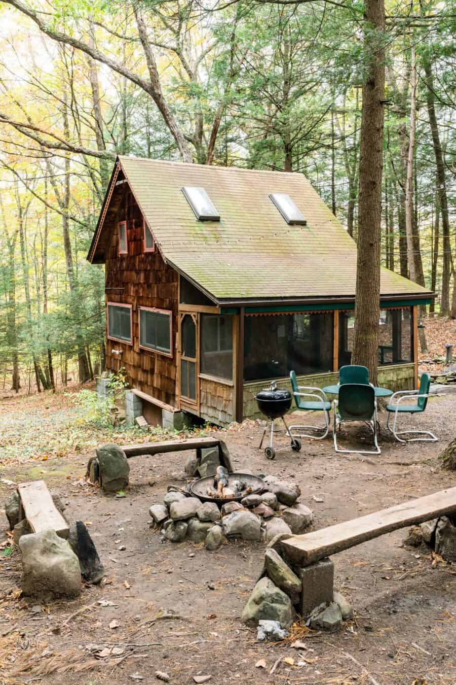 Charming tiny house nestled among tall trees in the Catskill forest, perfect for small space living.