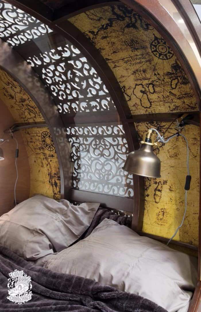 Decorative filigree and transparent acrylic skylight letting natural light into the steampunk teardrop trailer cabin