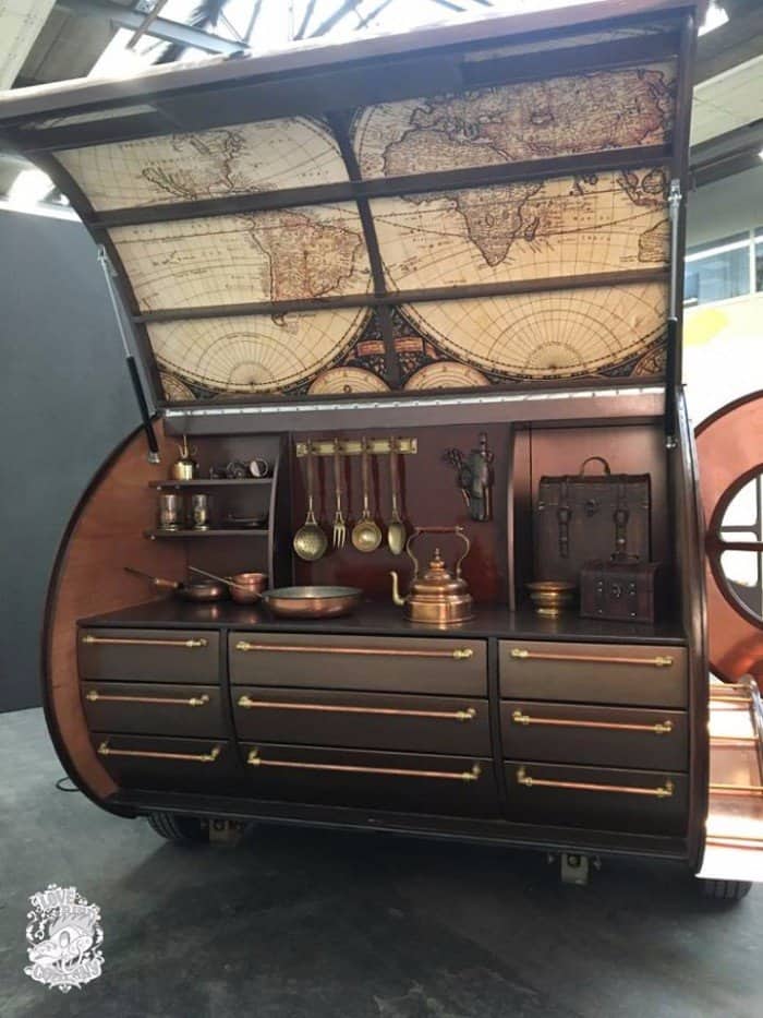 Galley of the steampunk teardrop trailer with nine drawers fitted with copper pipe handles