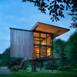 steel-clad-tiny-modern-cabin-with-shutters-on-stilts-01