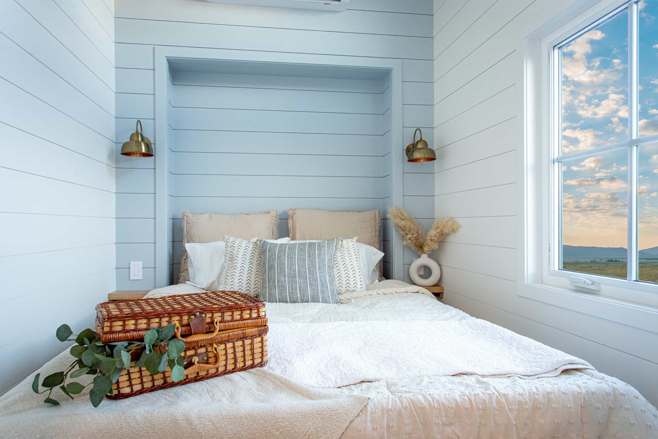 Summit Boho main-floor bedroom alcove: light bedding, soft blue accents, white walls