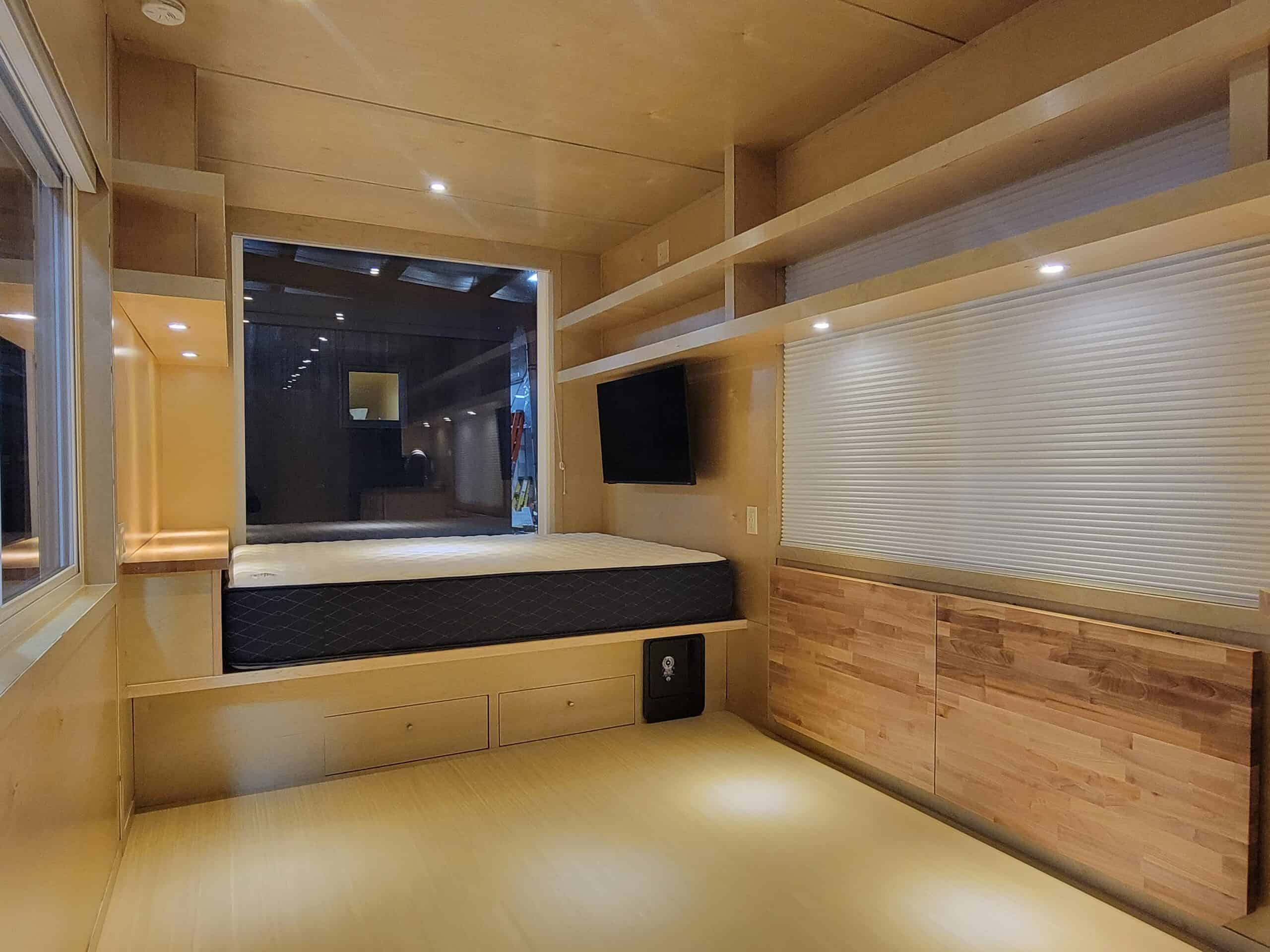 Modern tiny house interior with cozy sleeping area and wooden accents.