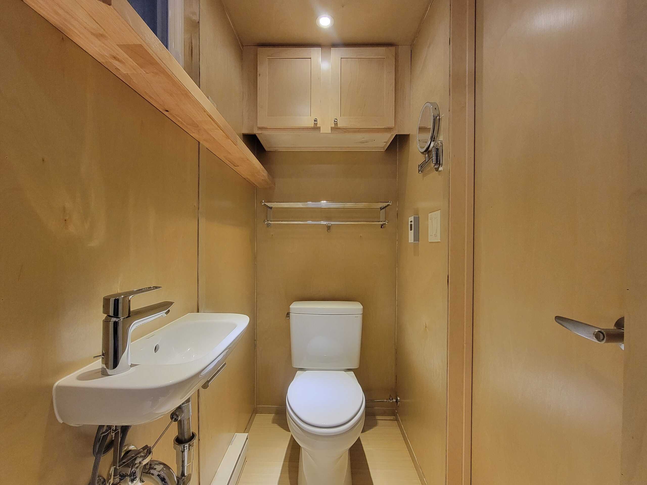 Bathroom in a tiny house with compact sink and toilet.