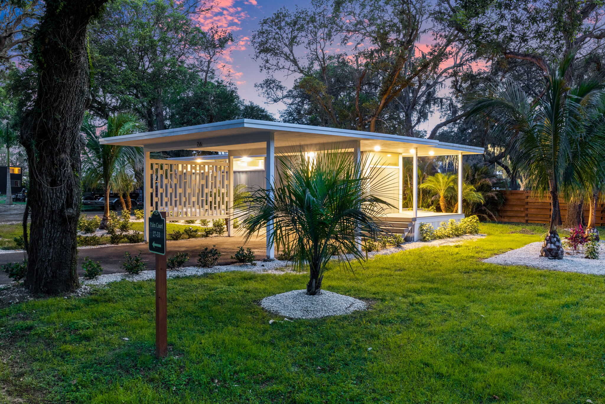 Cozy tiny house featuring a sleek, contemporary style surrounded by lush greenery. Perfect for minim.