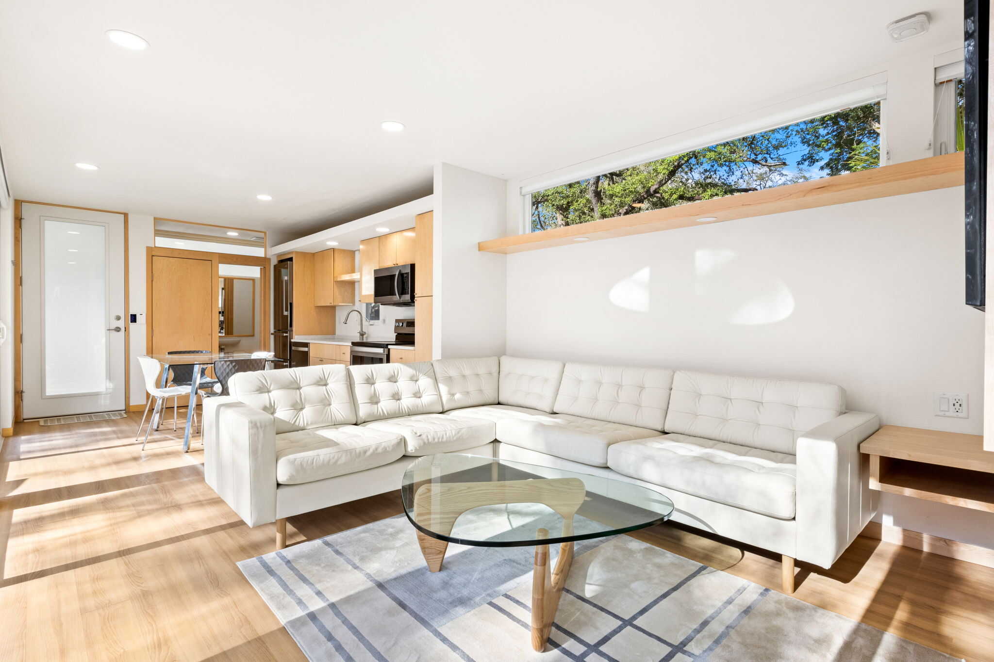 Bright, open-concept tiny house interior with minimalist design and natural light.