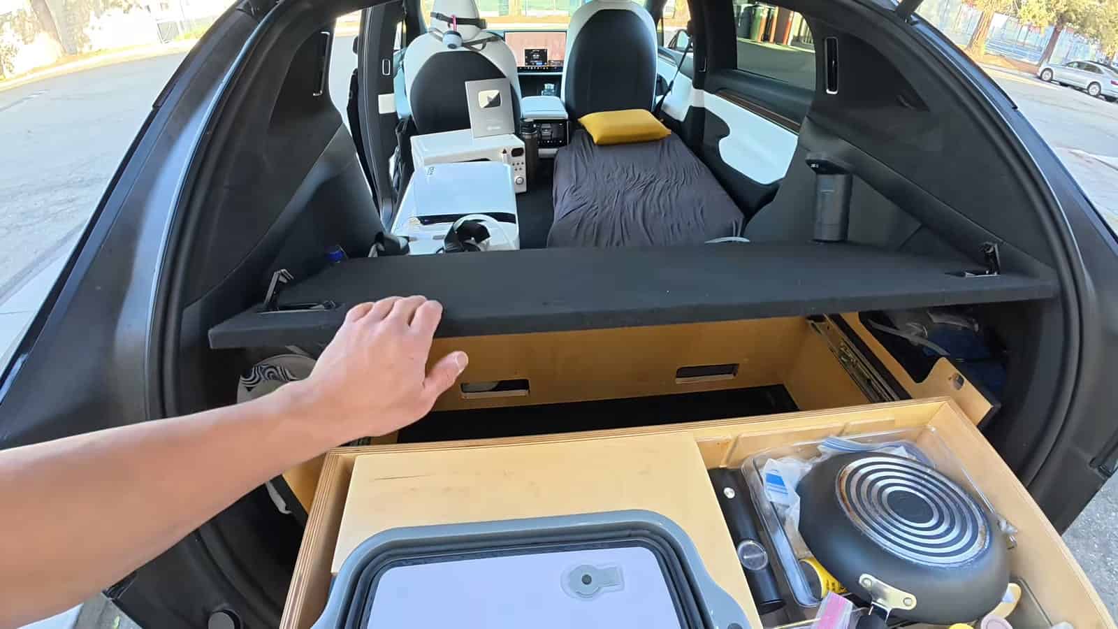Cooking gear and sink basin stored in a slide-out drawer in a Tesla Model X