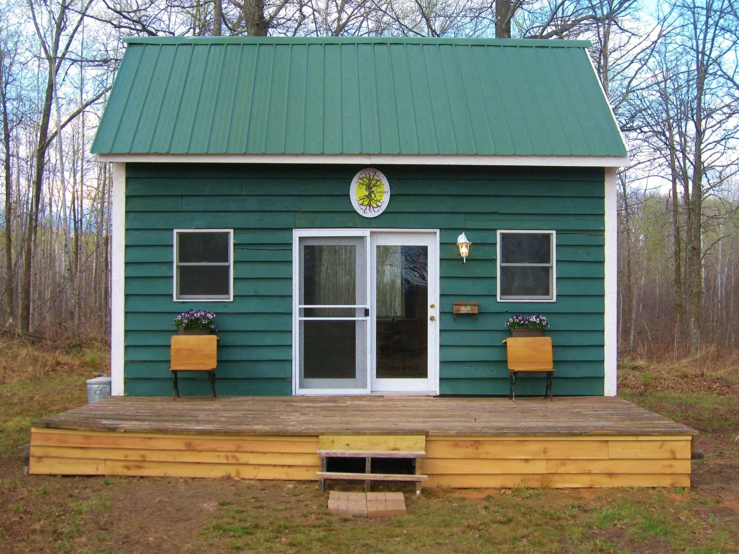 Cabin with tree-logo plaque at The Sanctuary Minnesota