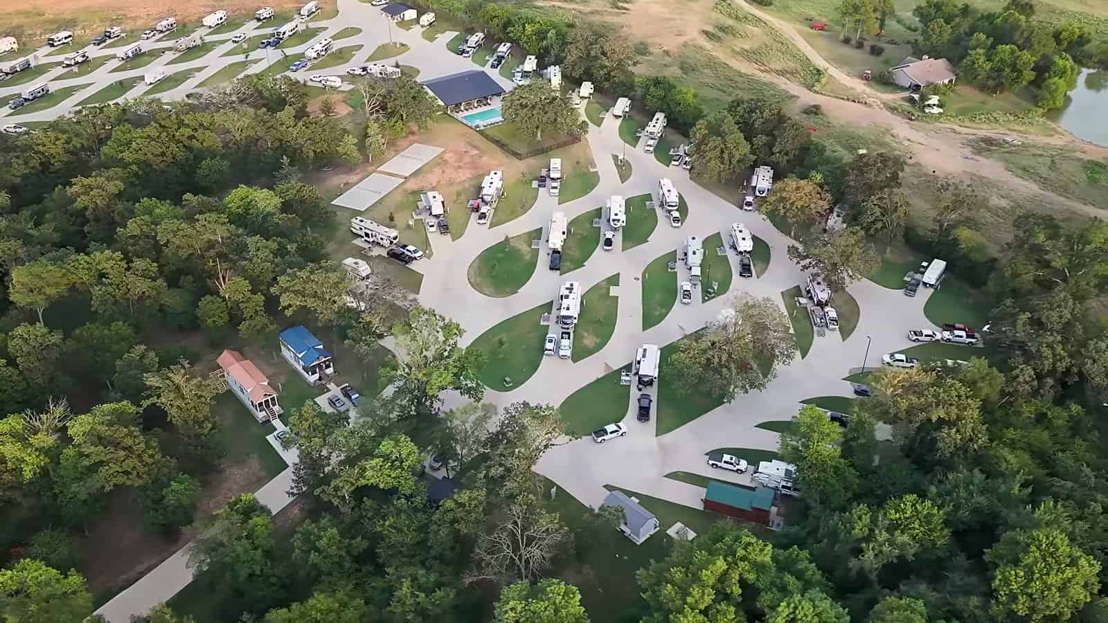 Aerial view of The Oaks on 37 RV and tiny home community with winding roads, RV sites and trees in Mount Vernon, Texas