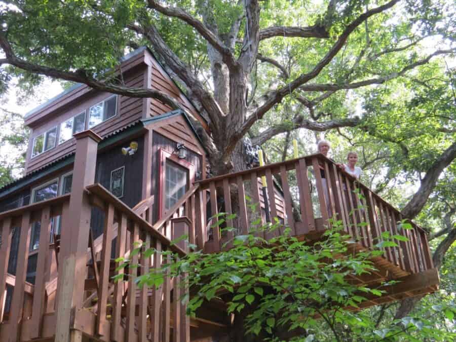 Multi-level White Oak Treehouse wrapped around a large oak with deck and loft windows, Timber Ridge Outpost, Elizabethtown Illinois