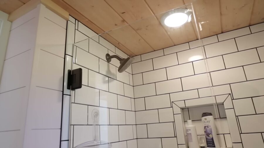 Walk-in subway tile shower with a built-in niche
