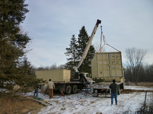 Shipping Container Being Loaded on A Flatbed Truck
