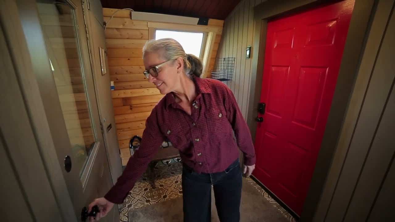 Entry foyer with a red exterior door and Denise at an interior door