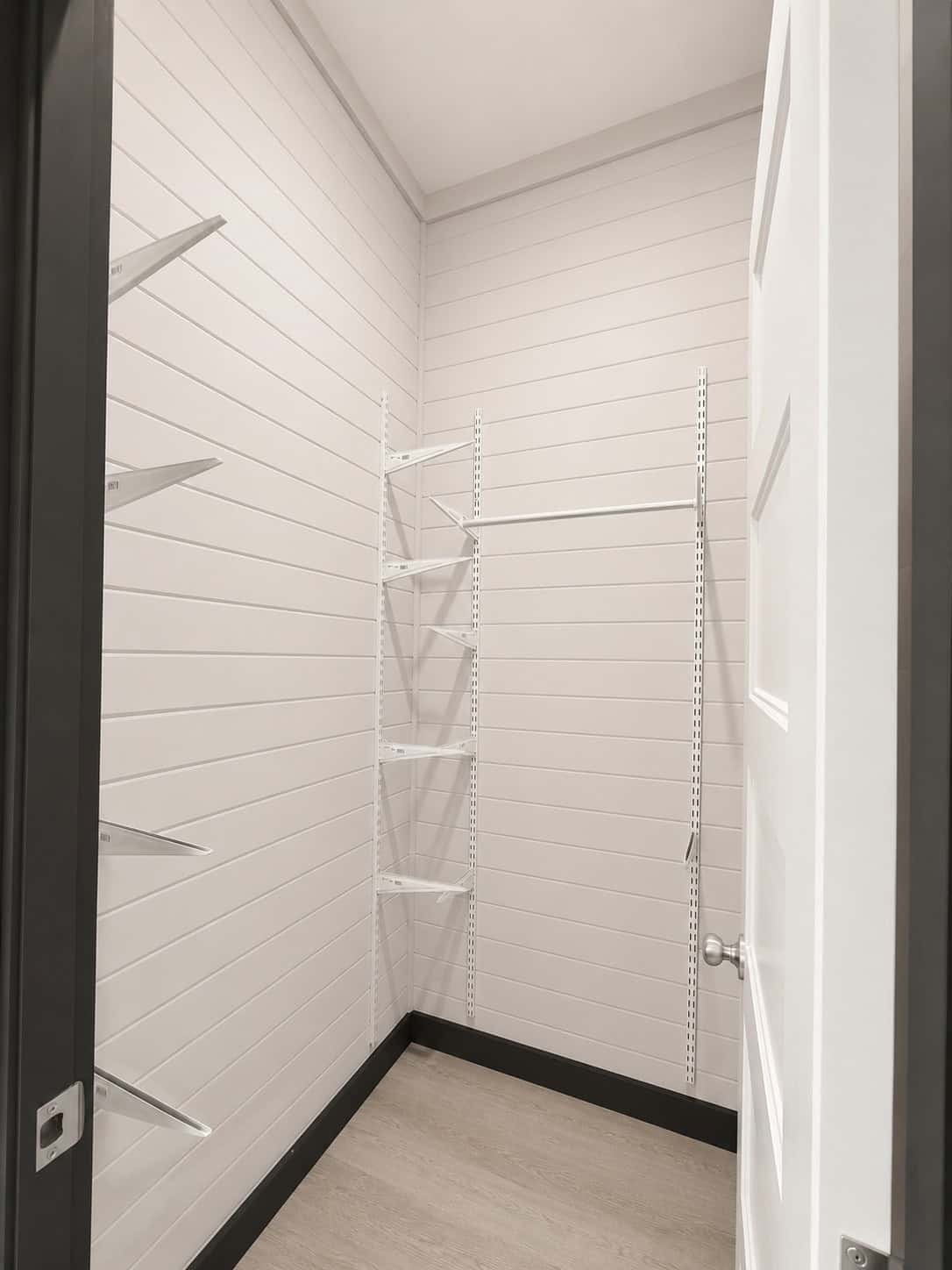 Empty closet with white wire shelving and a hanging rod