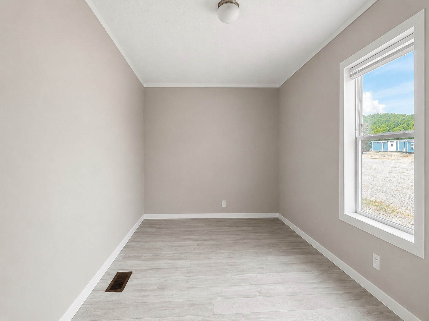 Tiny Life Urban empty bedroom toward window
