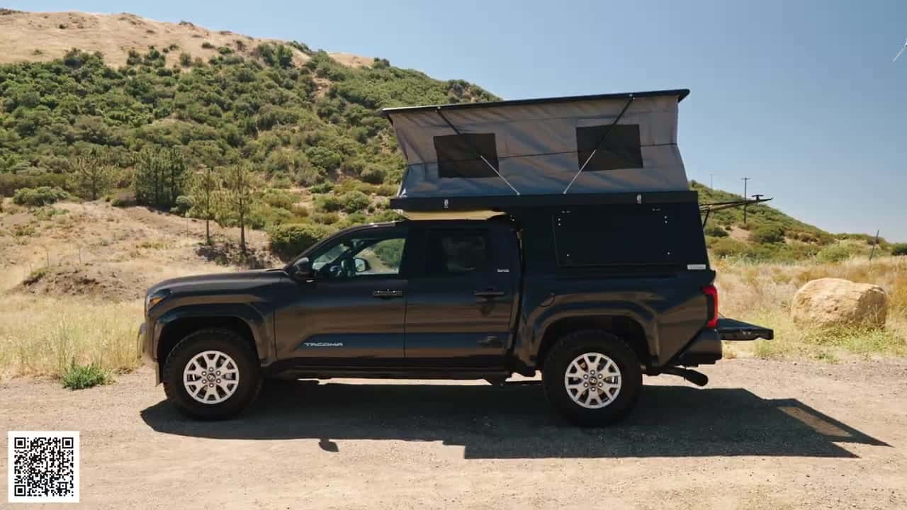 Side profile of a Tacoma with the Badlands pop-up fully raised, vertical gray tent walls with two mesh windows and tailgate down