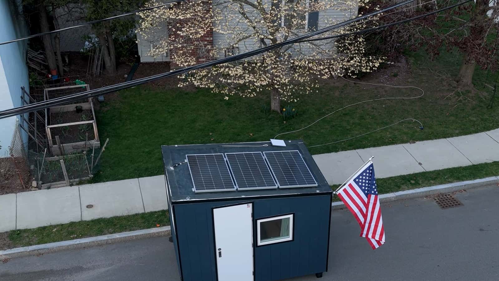 Drone view of the Uplift Micro Home roof showing three solar panels and a Starlink satellite dish