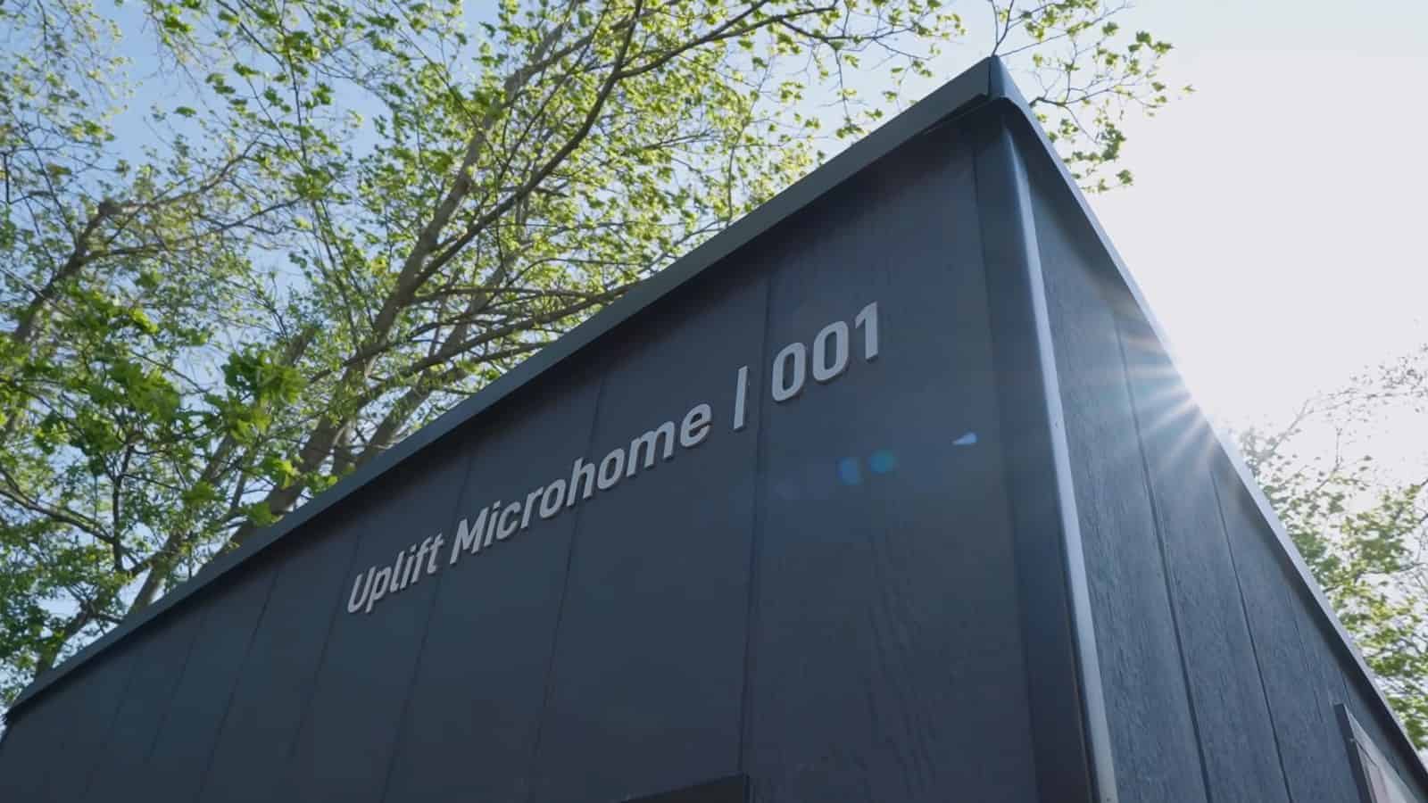 Low angle view of the dark steel-clad Uplift Microhome 001 against the sky