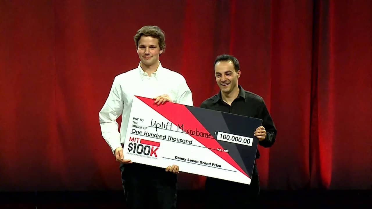 Uplift Micro Home co-founders holding the MIT 100K grand prize check