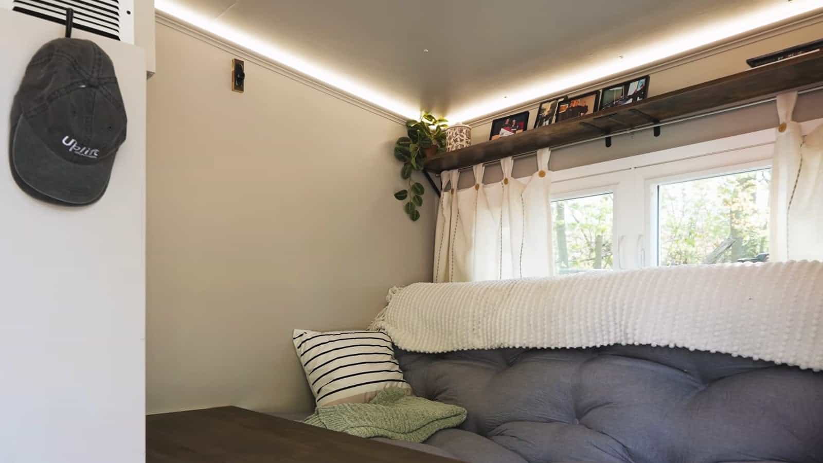Uplift Micro Home interior with the seating area and desk surface deployed