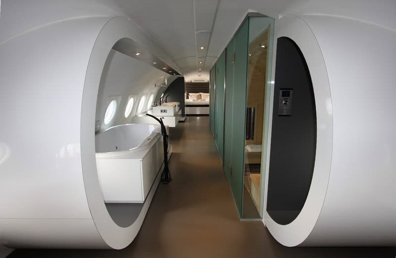 Looking aft down the white fuselage: jacuzzi, infrared sauna, kingsize bed at the tail