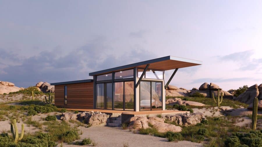 Wheelhaus Lookout exterior: shed roof, floor-to-ceiling glass, wood cladding, covered deck over desert rock