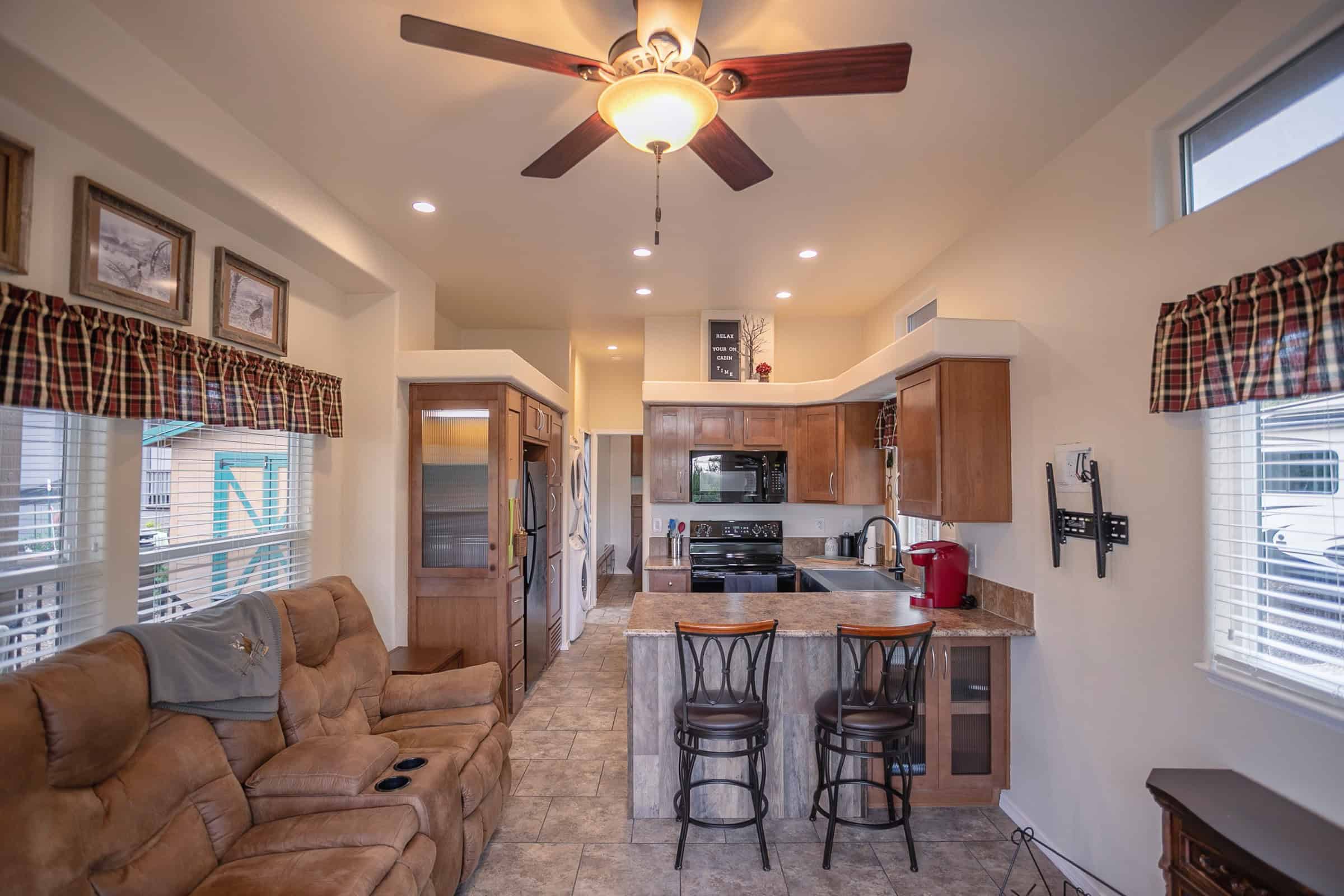 Living room with a sofa in the foreground and a kitchen farther back