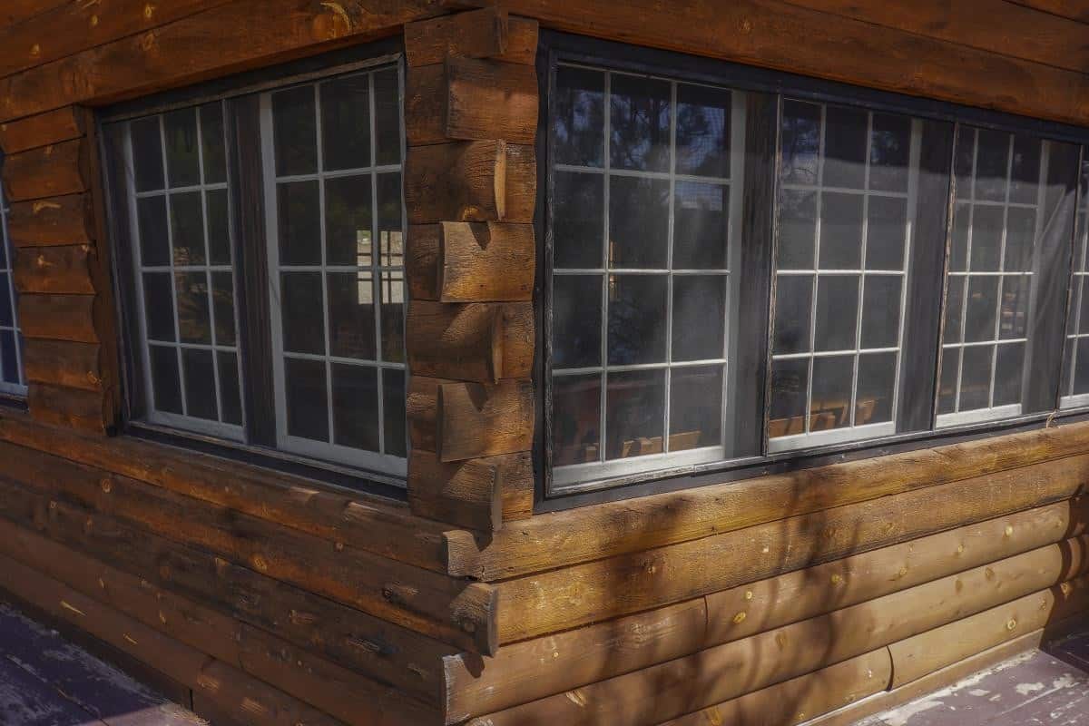 Exterior corner of the log Woods Cabin with multi-pane windows