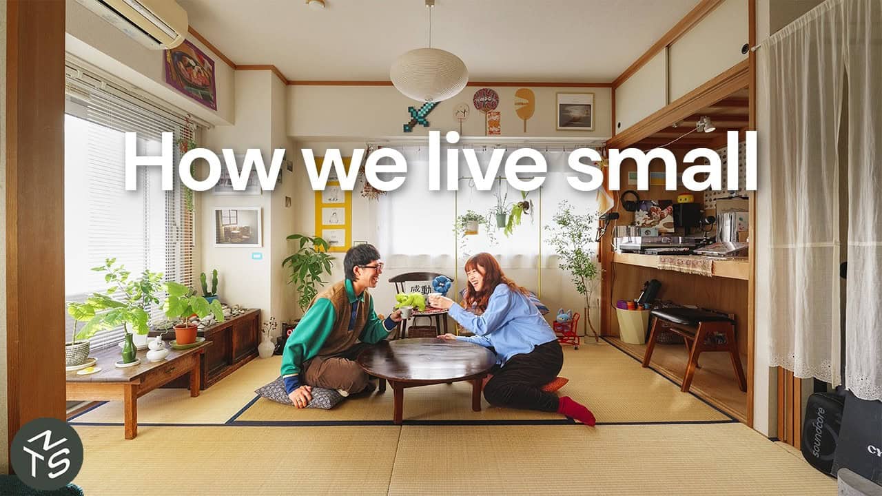 Ryu and Kamado sitting on tatami at a low round table in Yoshinani House, plants on a bench, a paper lantern overhead